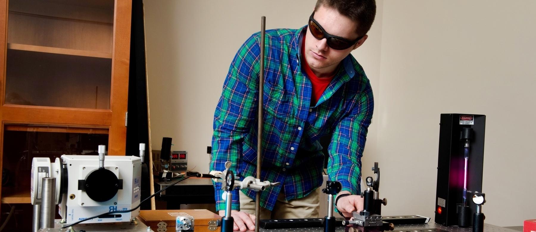 Student using laser in physics lab