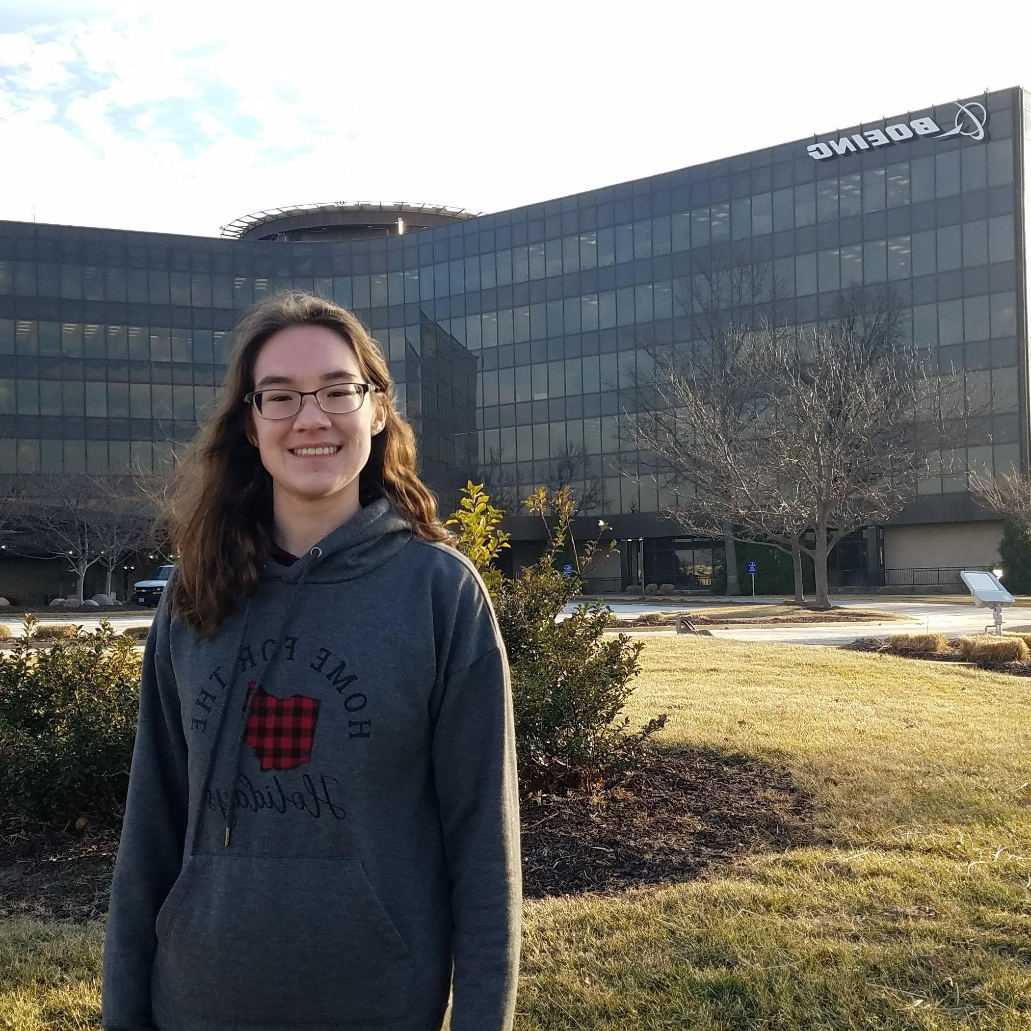 dana lucas standing in front of building